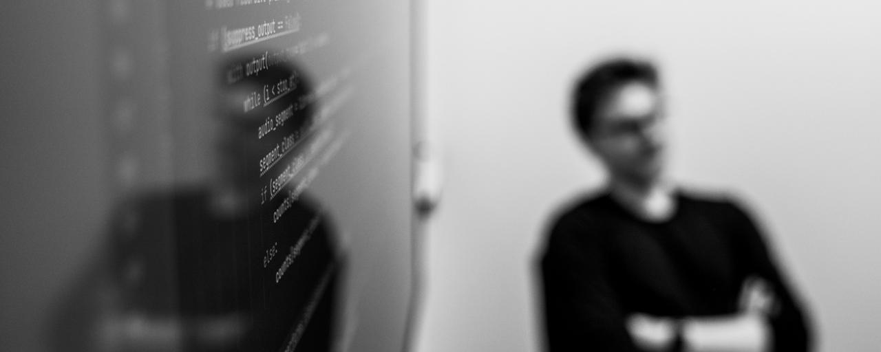 Man sitting next to code